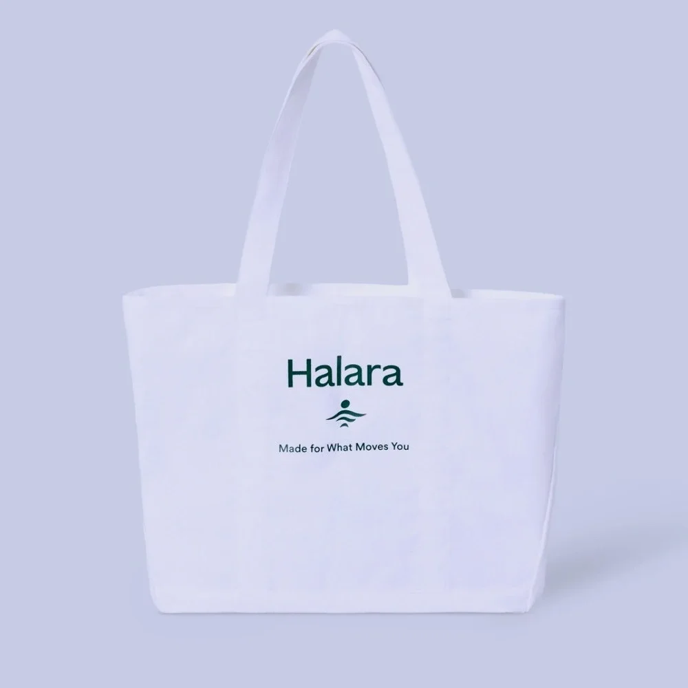 Women's white Halara canvas tote bag with a‎ green logo and text NWT travel gym